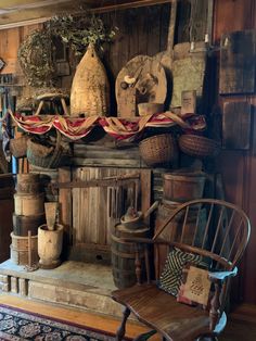 an old fashioned fireplace with baskets and other items