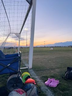 a soccer goal with several different items on the ground