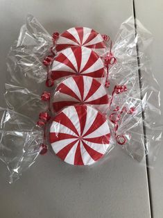 two red and white candy canes wrapped in plastic