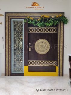 an entrance to a building decorated with flowers and leaves on the door, surrounded by yellow trimmings