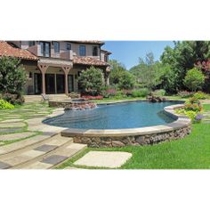 a large backyard with a pool and landscaping