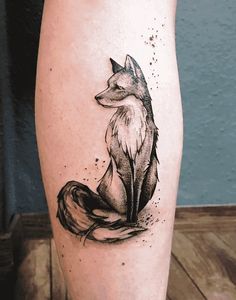 a black and white tattoo of a fox on the leg