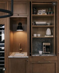 a kitchen with wooden cabinets and marble counter tops, coffee maker on the far wall