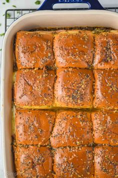 a casserole dish filled with baked bread and topped with seasoning sprinkles