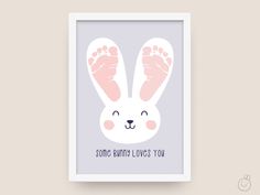 a white frame with a pink bunny's paw on it