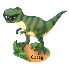 a toy dinosaur with its mouth open sitting on top of a piece of paper that says casey