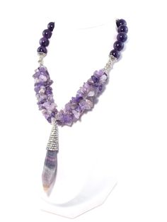 This stunning piece makes gorgeous statement! Semi precious Amethyst stones coupled with this beautiful semi precious crystal Fluorite pendant create an regal look with a rich luxurious feel! Silver plated accents add an elegant touch and help to complete the look! Necklace also includes extender chain so as to adjust Luxury Amethyst Jewel Necklaces, Luxury Amethyst Pendant Jewelry, Luxury Amethyst Jewel Necklace, Luxury Amethyst Necklace With Jewels, Luxury Amethyst Necklaces With Natural Stones, Luxury Gemstone Beads Jewelry For Healing, Luxury Purple Necklace With Gemstone Beads, Luxury Amethyst Necklace With Natural Stones, Luxury Healing Gemstone Beads Jewelry