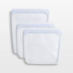 three white plastic containers with lids on them