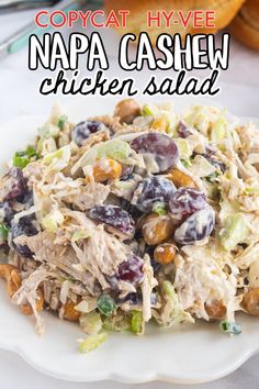 a white plate topped with chicken salad and grapes