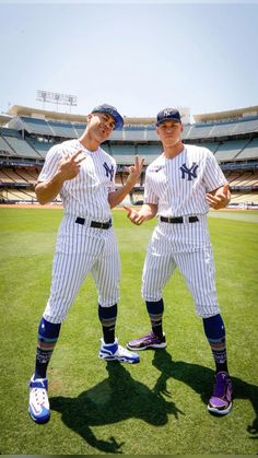 two baseball players are standing on the field