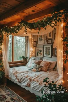 a bed sitting under a window covered in lots of lights next to a potted plant