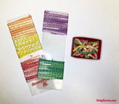 several pieces of colorful fabric sitting on top of a white table next to each other