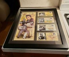 framed elvis presley memorabilia on display in an old - fashioned kitchen cabinet with stove and microwave