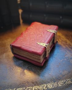 a red book sitting on top of a wooden table