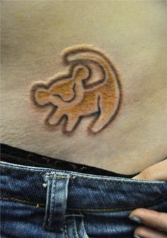 a woman's stomach with an animal tattoo on the side of her belly,