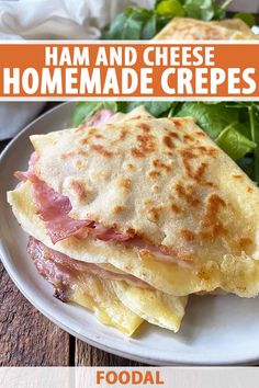 ham and cheese homemade crepes on a white plate