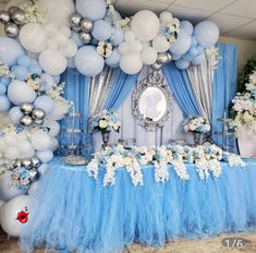 a blue and white party setup with balloons