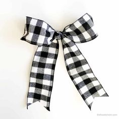 a black and white checkered bow tied to a wall