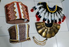 three native american headdresses are laid out on the floor next to each other