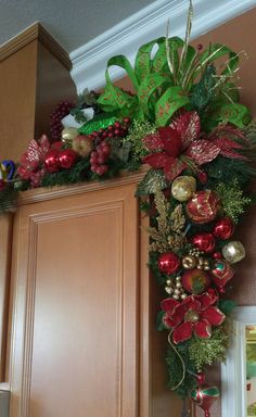 a christmas wreath on top of a cabinet