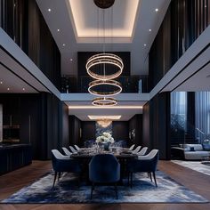 an elegant dining room with chandelier and blue chairs in front of the table