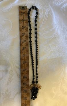 "This striking vintage black necklace features an attached grape cluster pendant. The jet black beads are faceted glass and the 1950's/60's necklace is in superb condition, with the grape leaves and stem accented in gold tone. Excellent for vintage looks or mix old and new for fun. Measures approximately: Pendant 2 1/2\" X 2\" X necklace length is 33\" As always, local pickup is available and preferred so that you may see all of our other wonderful items. Aphrodite's Antiques & Gifts 11 Milt Antique Black Beaded Necklace, Antique Black Beaded Necklaces, Adjustable Black Vintage Beaded Necklace, Vintage Black Beaded Necklace For Party, Vintage Black Necklaces For Evening, Vintage Black Necklace For Evening, Vintage Adjustable Faceted Beaded Necklaces, Vintage Black Bead Necklaces For Evening, Vintage Necklaces With Black Beads For Jewelry Making