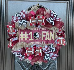 a florida state football wreath with the number one fan on it is hanging on a door