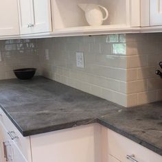 a counter top in a kitchen with white cabinets