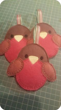 three felt bird ornaments on a table