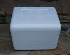 a white box sitting on top of a stone floor