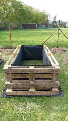 a wooden crate sitting on top of a green field