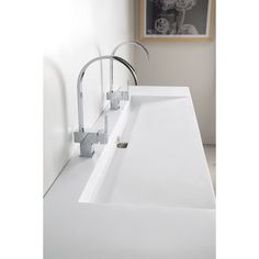 a white bathroom sink with chrome faucet and soap dispenser