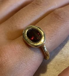 This simple 9 ct yellow gold ring featuring a deep red garnet is rustic and elemental . The textured gold makes this unique ring both organic and luxe Pomegranate Ring, Garnet And Diamond Ring, Talisman Necklace, Solitaire Rings, Garnet And Gold, Etsy Gold Ring, Jewelry Lookbook, Unique Ring, Yellow Gold Ring