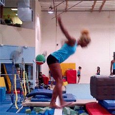 a woman is doing tricks on a trampoline