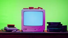 an old tv sitting on top of a wooden table next to a printer and other electronics