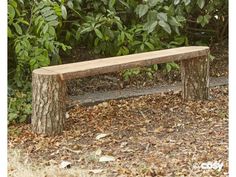 a wooden bench sitting in the middle of a forest