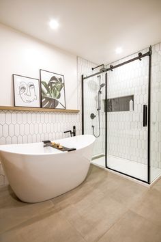 a bathroom with a tub, sink and shower stall in it's center area