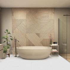 a bathroom with a large white bathtub next to a walk in shower and a potted plant