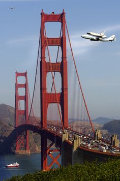 an airplane is flying over the golden gate bridge in san francisco, california with a space shuttle on it's back