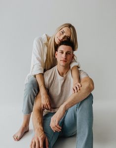 a man sitting on the back of a woman