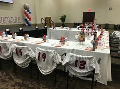 a baseball themed party setup with table cloths and centerpieces on the tables