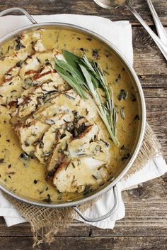 a pan filled with chicken covered in gravy