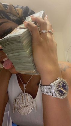 a woman holding money up to her face