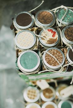 an open box filled with lots of different types of eyeshades on top of a table