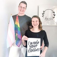 a man and woman standing next to each other holding signs that say made your clothes