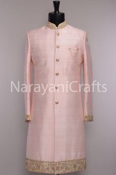 a man's pink sherwa with gold buttons on the chest and collar