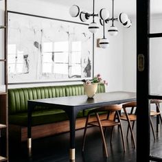 a dining room with green chairs and a table