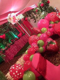 an arrangement of balloons and decorations in the shape of strawberrys