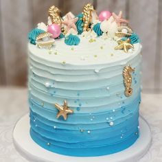 there is a blue and white cake with seahorses on it