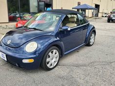 a blue car parked in front of a building